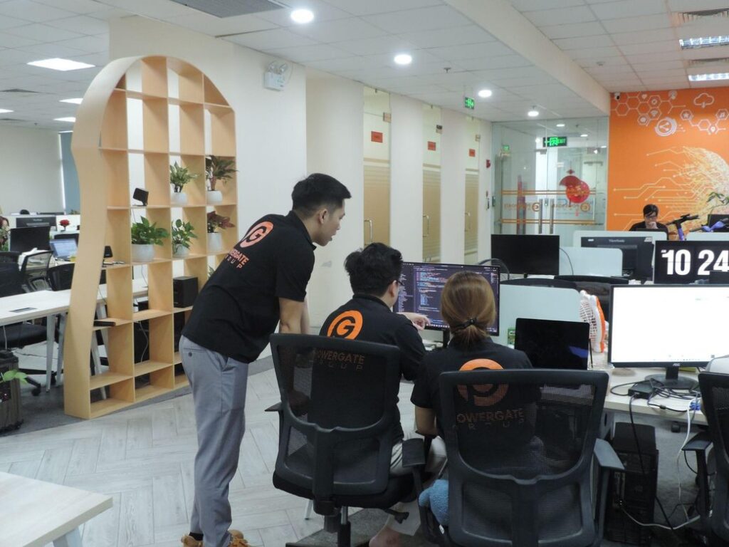 PowerGate Software team collaborating in a modern office environment.
